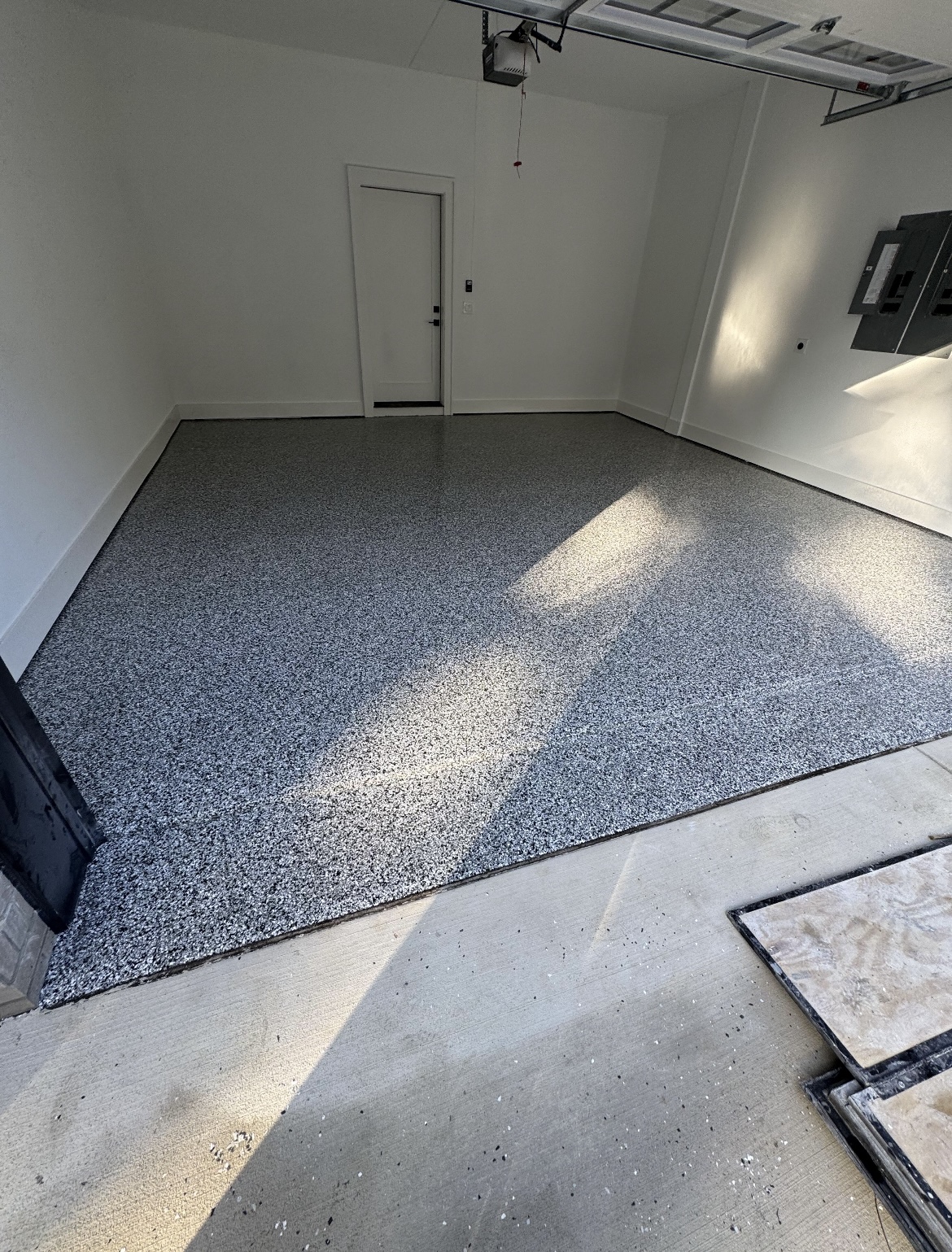 Premium gray flake concrete floor coating in a Minnesota garage