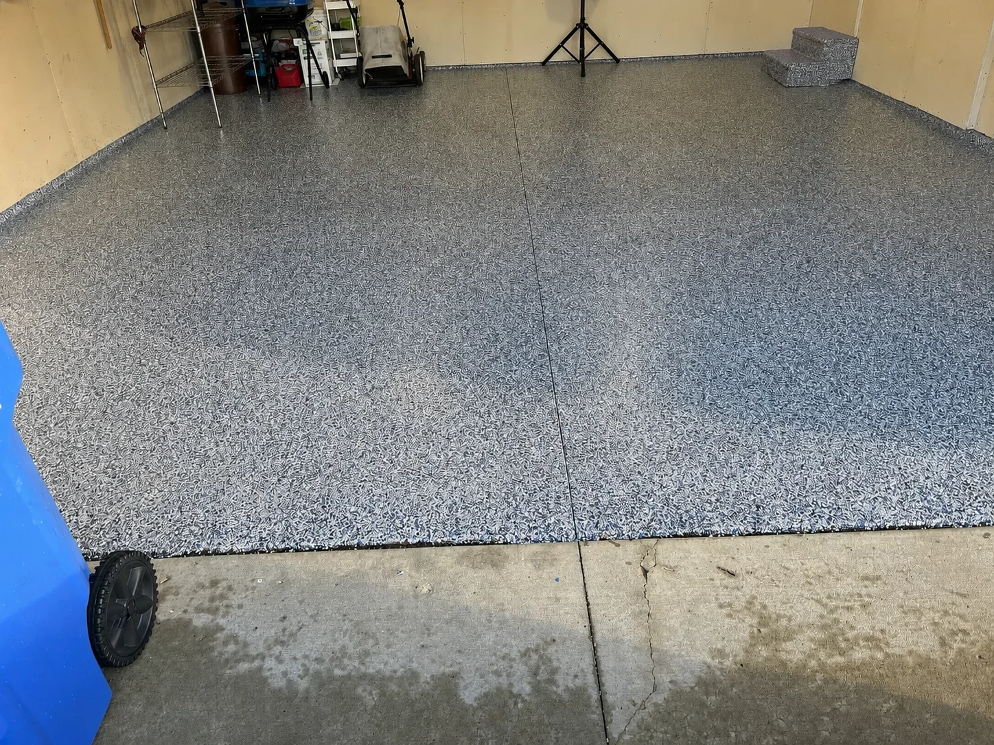 Gray speckled epoxy-coated garage floor with clean seams and finished edges